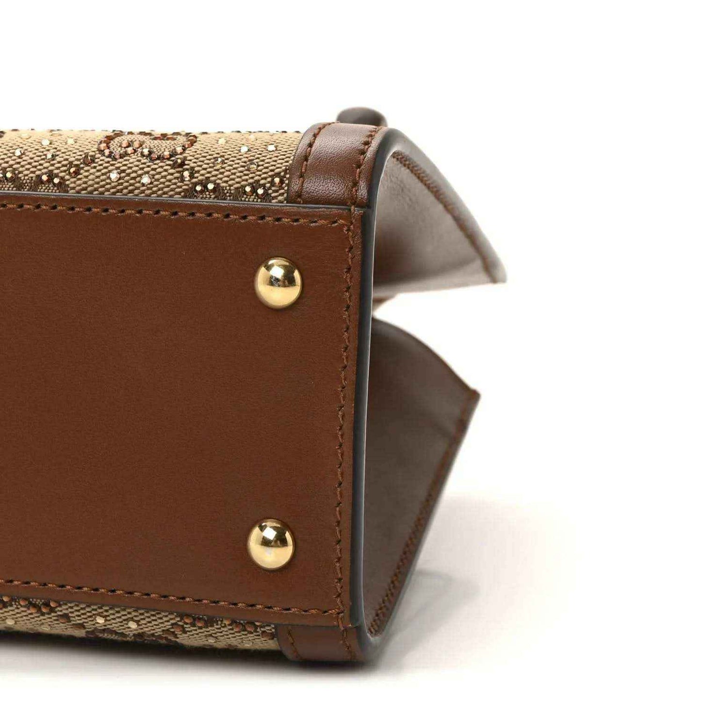 Gucci mini tote bag corner view, brown leather with gold studs and tan monogram canvas