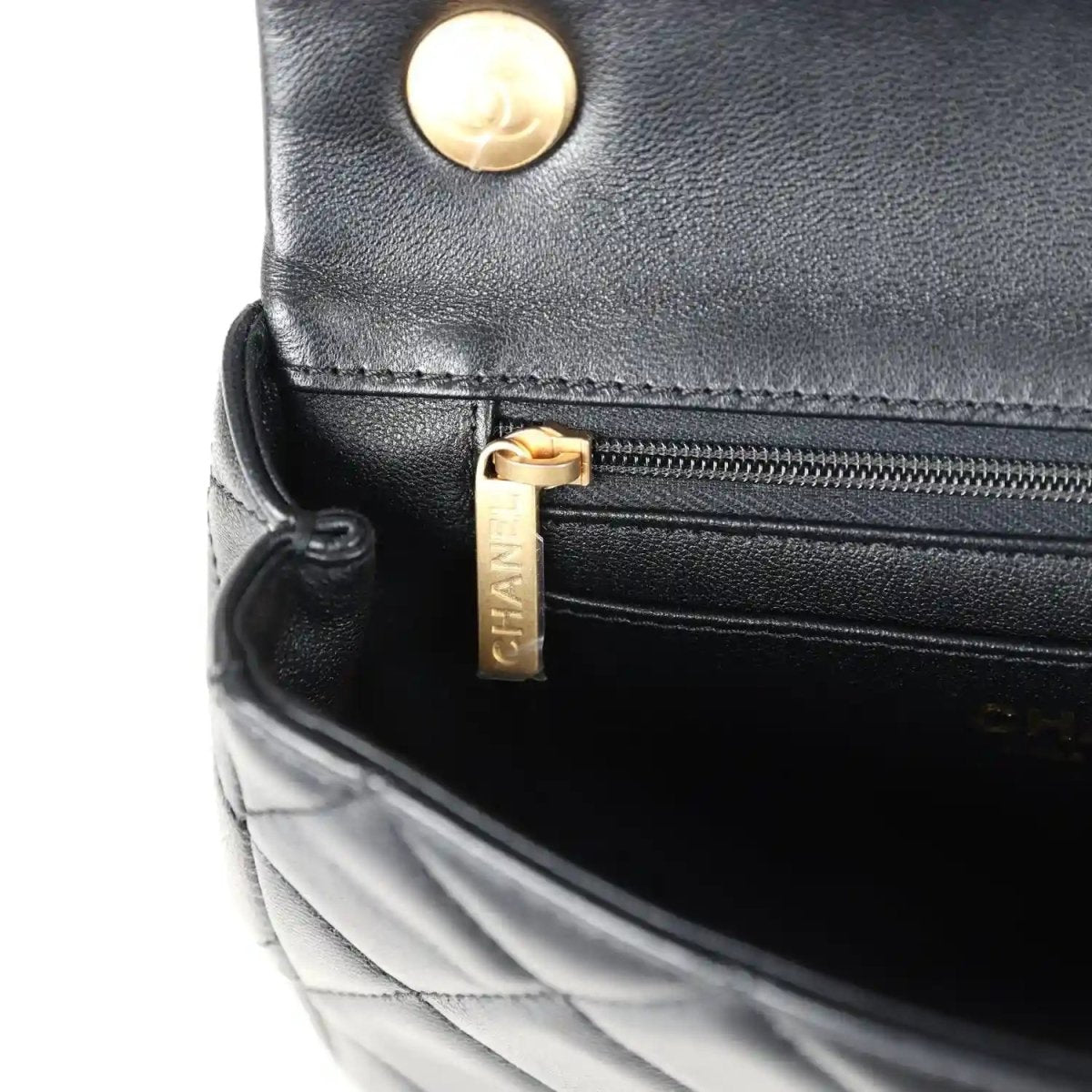 Black lambskin quilted flap bag with gold-tone button and zip pocket