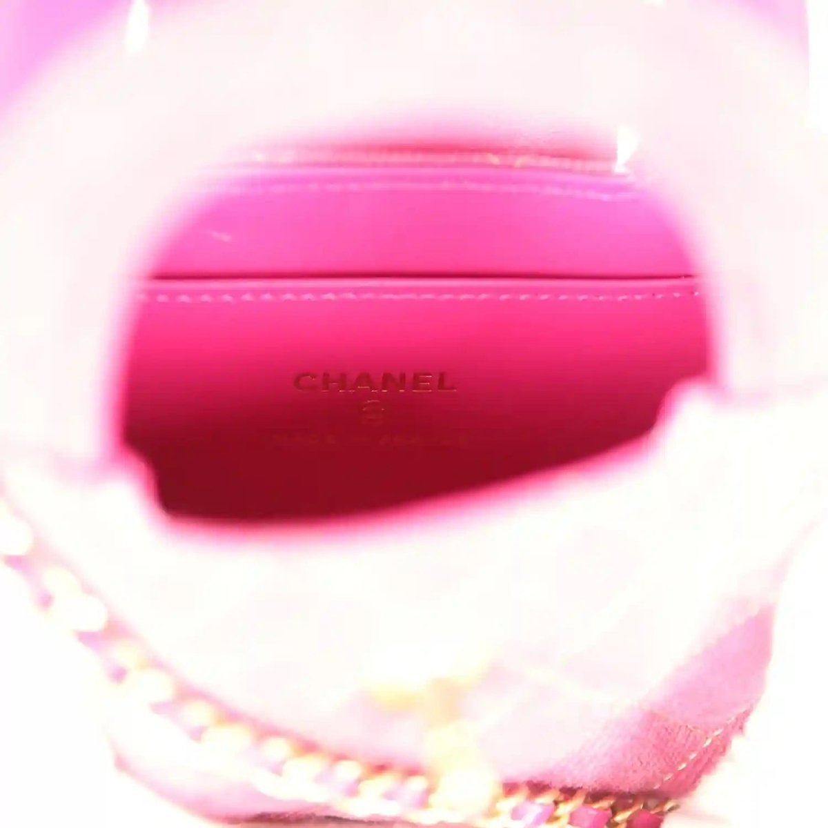 Fuchsia interior lining with embossed CHANEL logo and chain strap edge