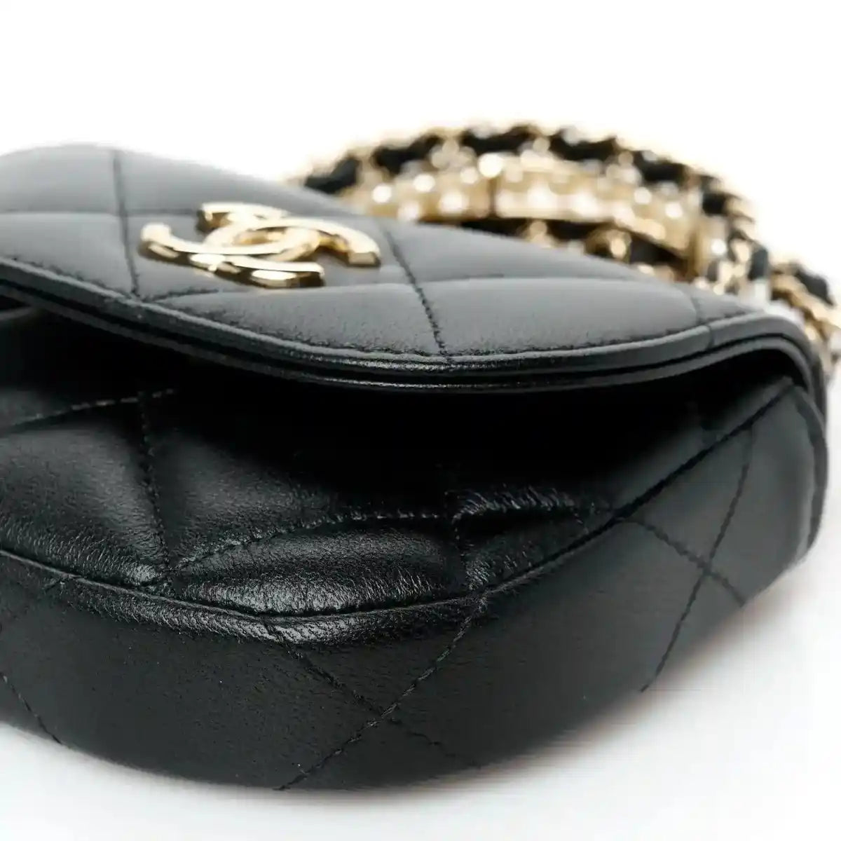 Quilted black leather clutch with gold clasp and stitched edge detail