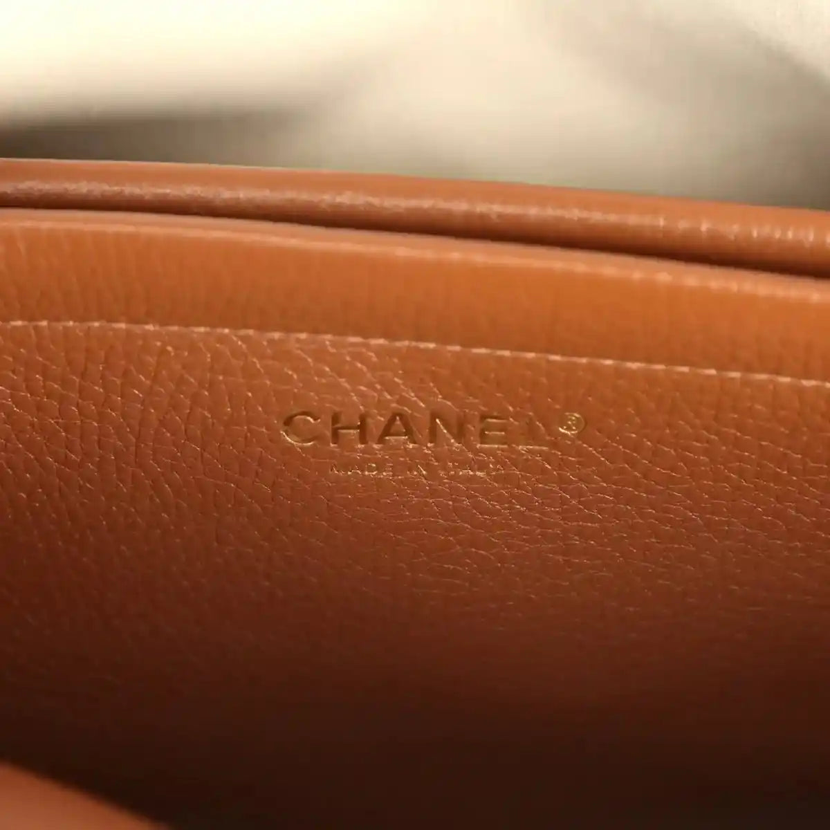 Chanel leather tote bag with CHANEL logo stamp on brown front panel