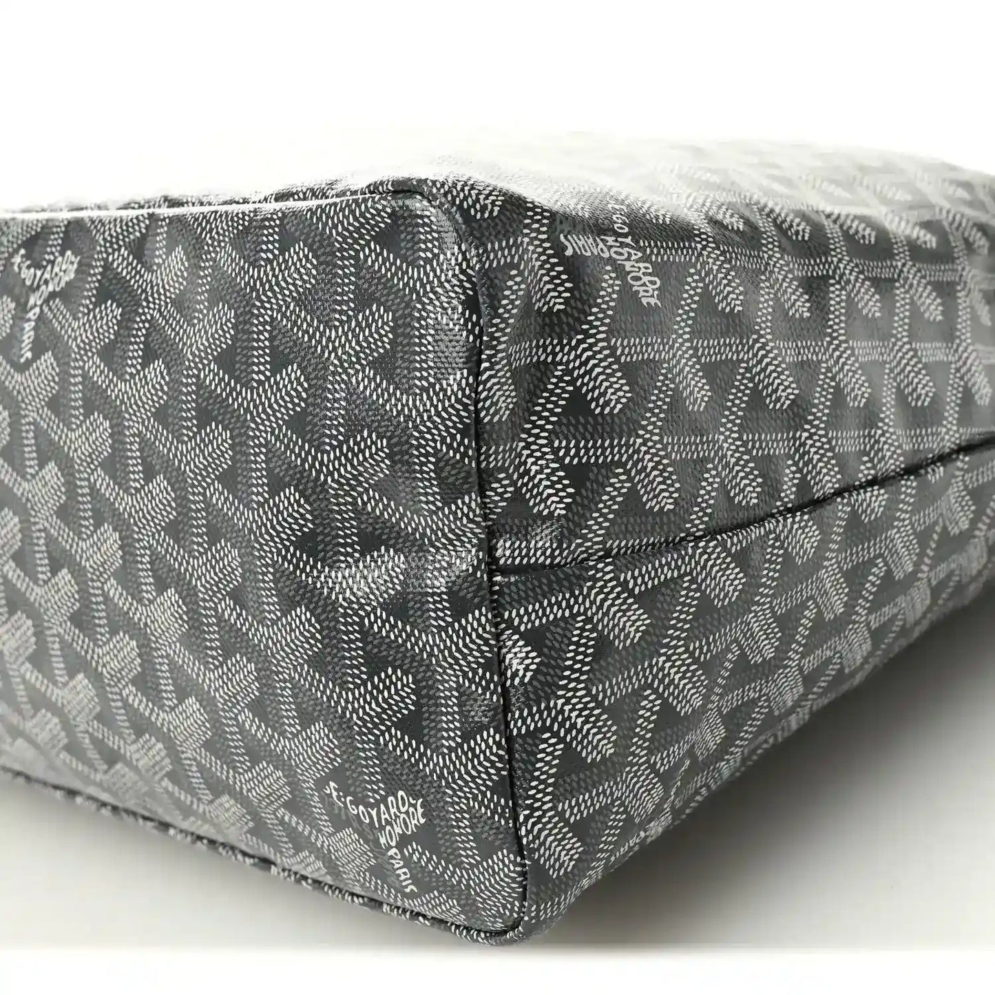 Grey canvas hobo bag with monogram pattern and stitched seams