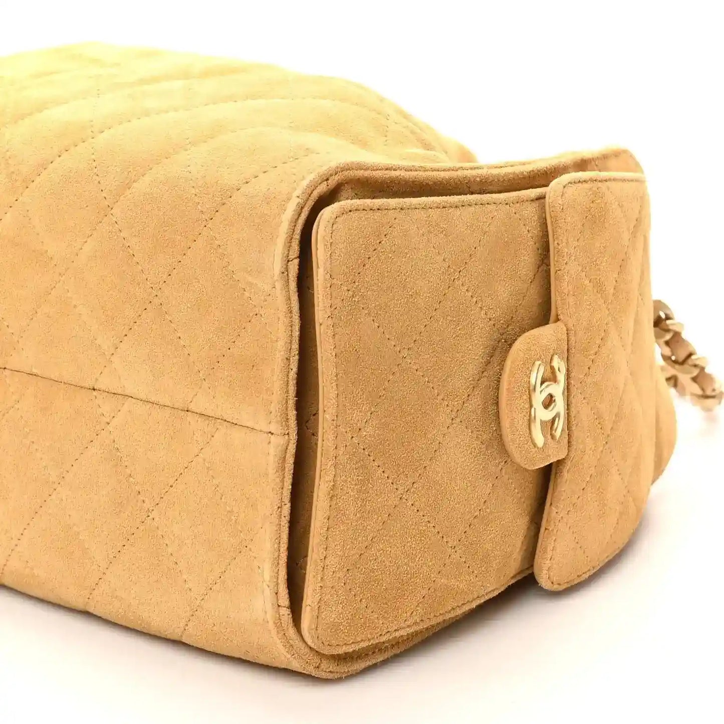 Chanel beige quilted suede handbag with front pocket, snap tab, and chain hardware
