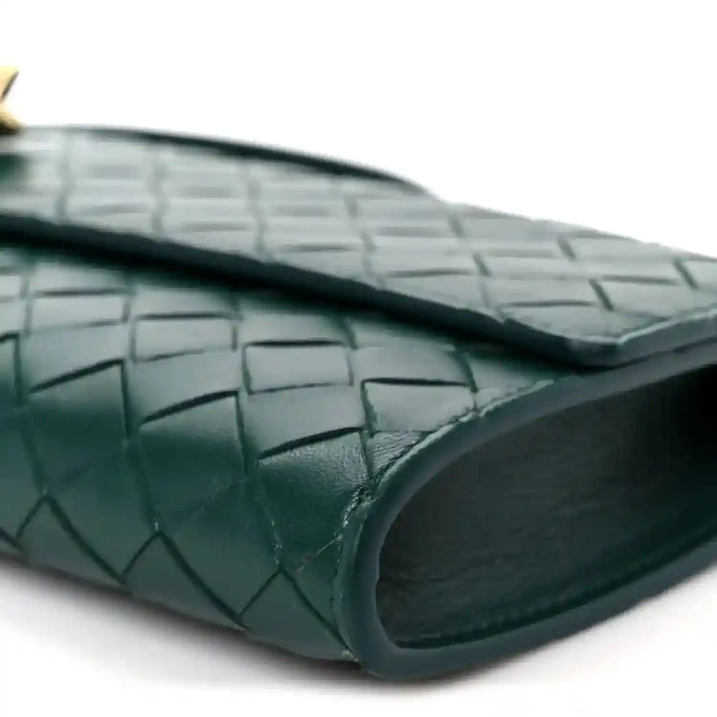 Emerald green Intrecciato leather clutch bag corner detail, top flap and stitched edge