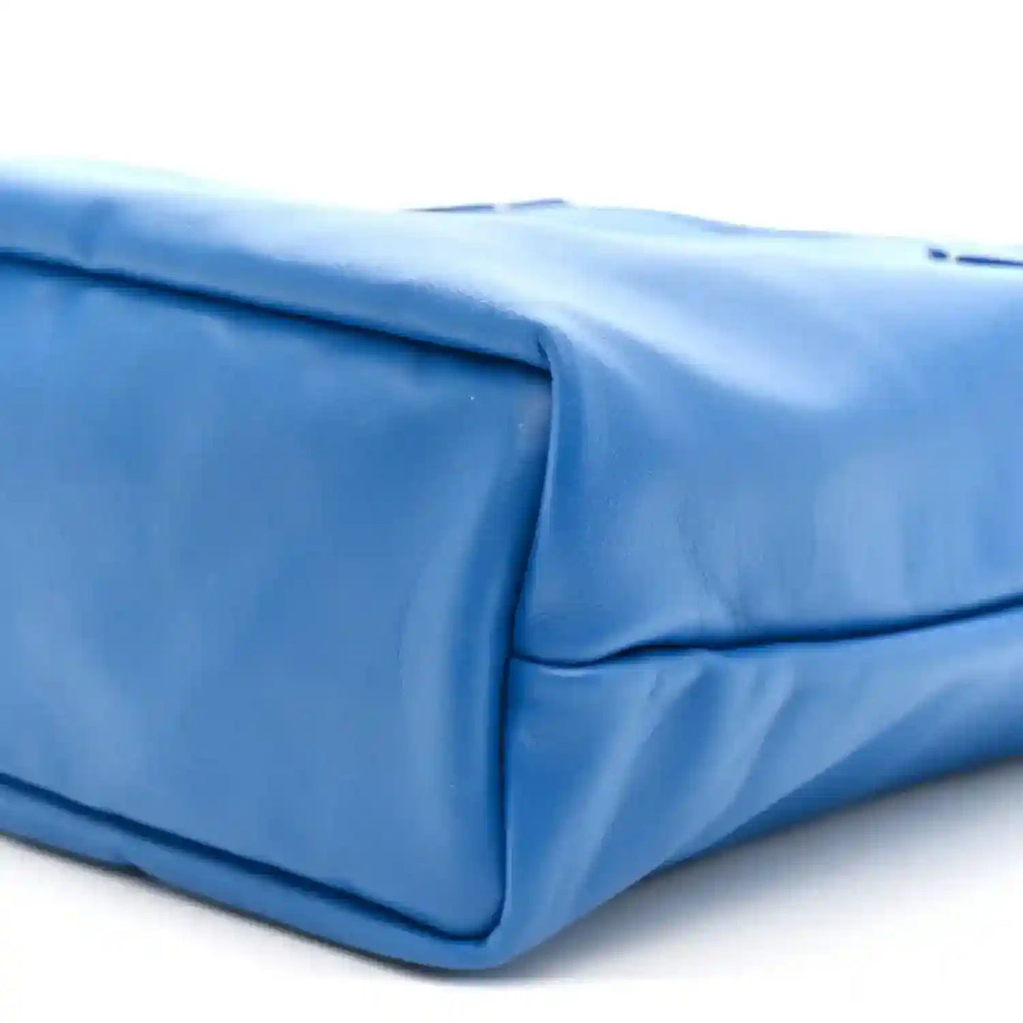 Mini reversible tote bag, smooth blue leather corner with seam line and rounded edge