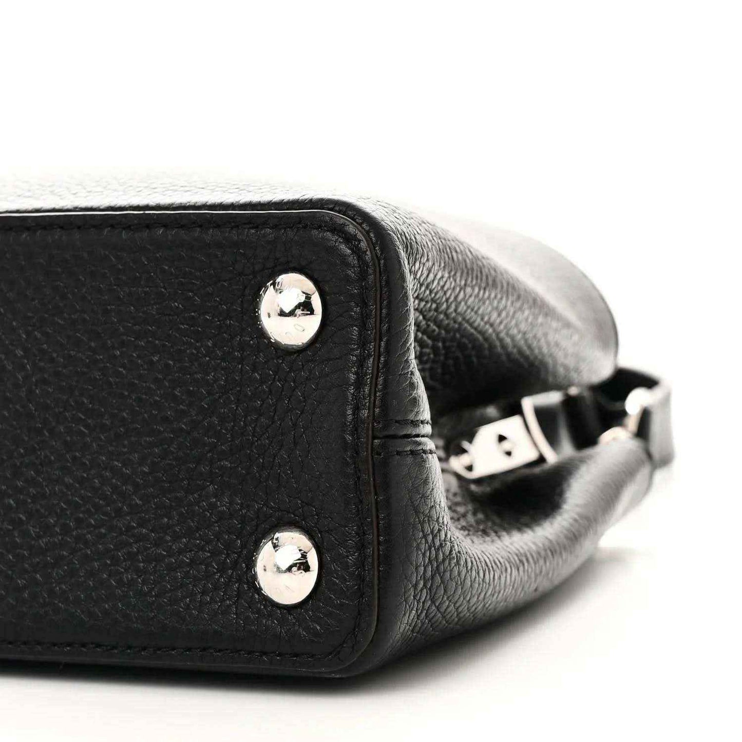 Black leather handbag side with silver studs and adjustable crossbody strap