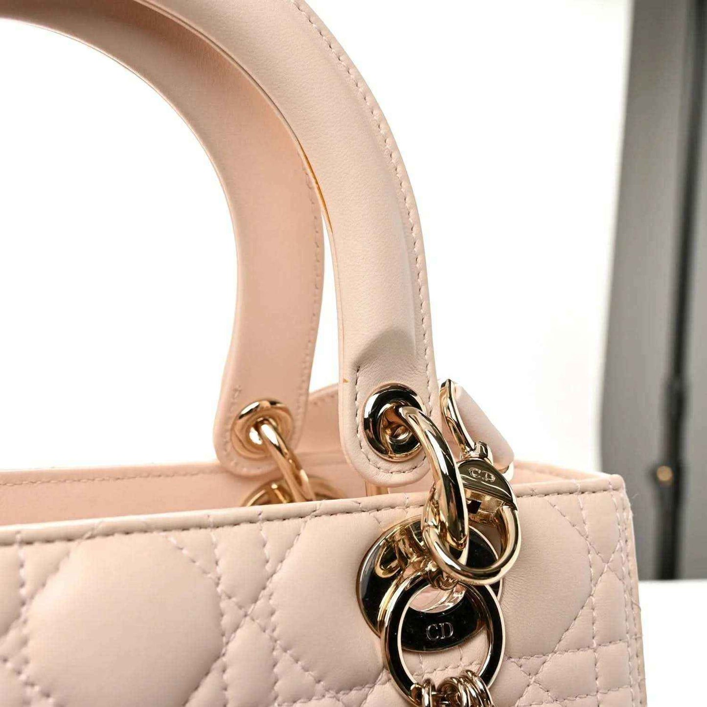 Powder pink quilted lambskin handbag with gold-tone rings and clasp, top handle