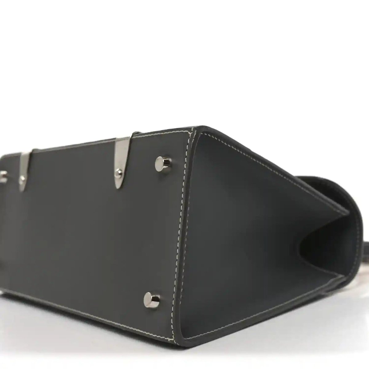 Black leather bag with open top, metal snap on side, and stitched trim