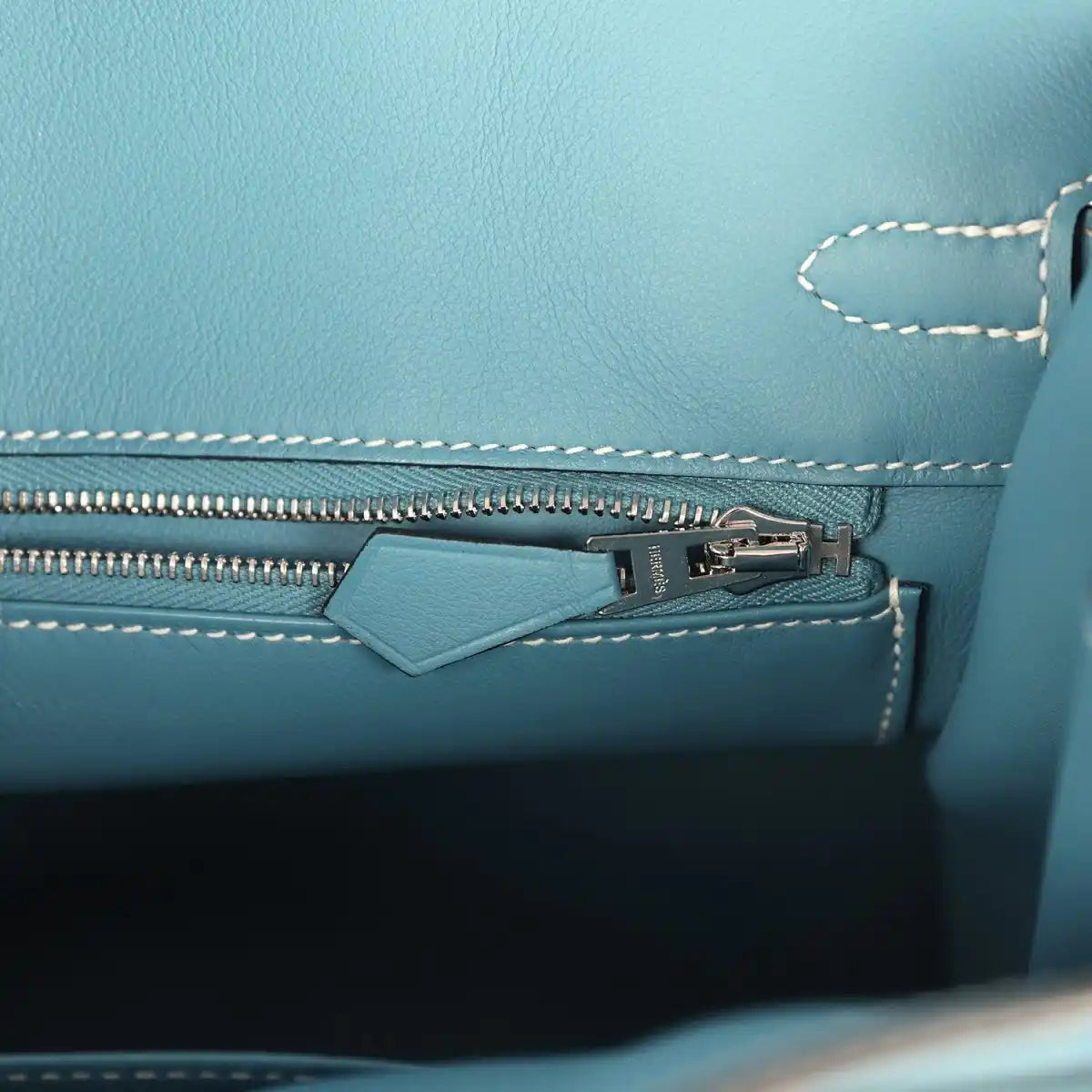 Blue Birkin 25 handbag interior view of zipper track and stitched edge