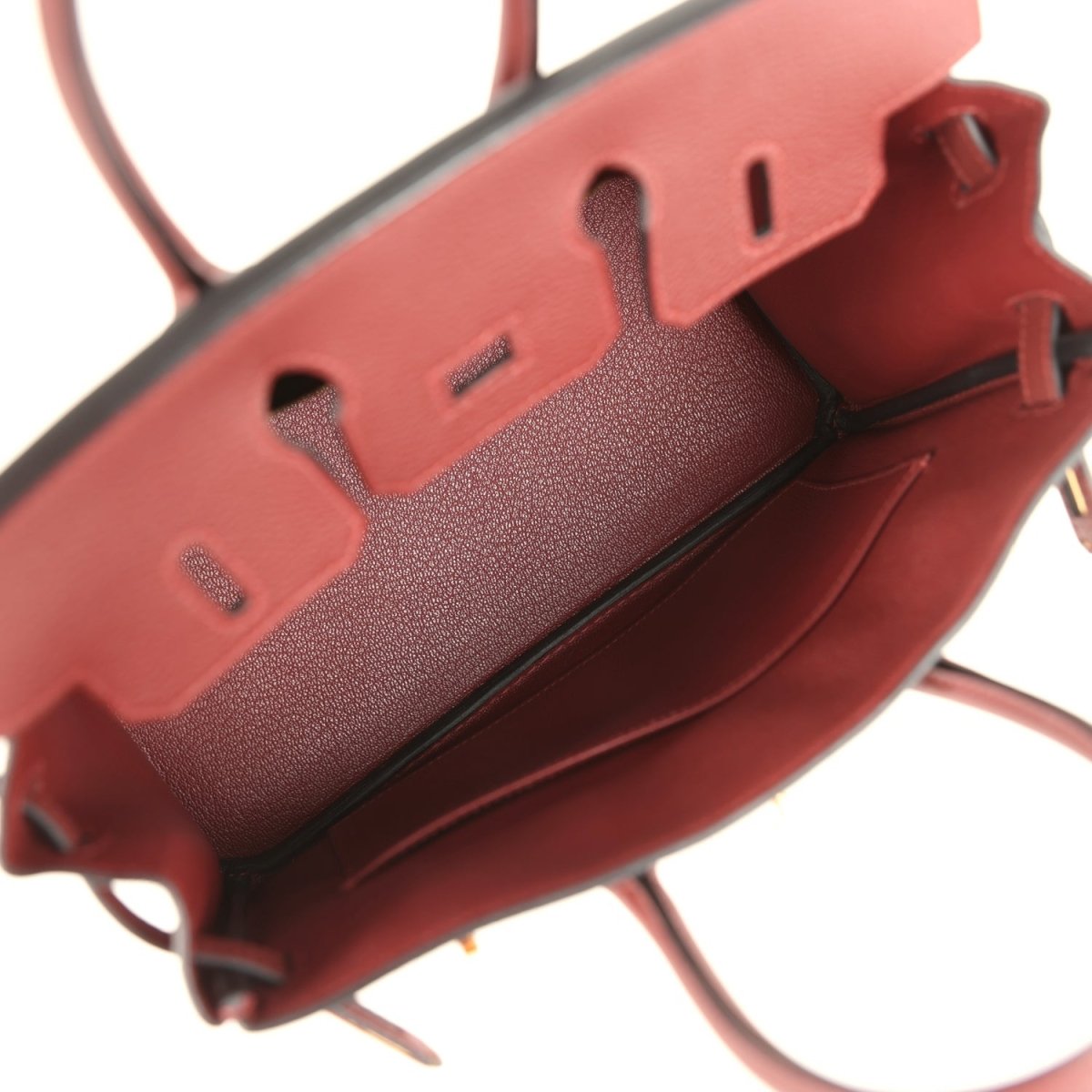 Burgundy leather handbag base with protective studs and strap attachment tabs.