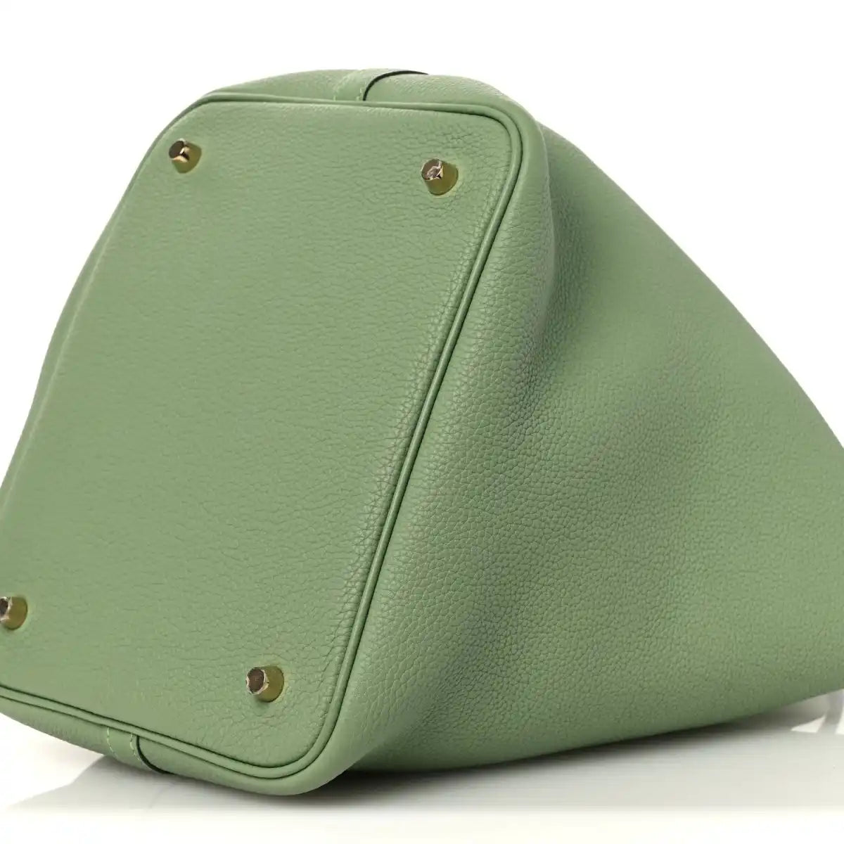 Green leather bucket bag side view with gold-tone studs on corner panels