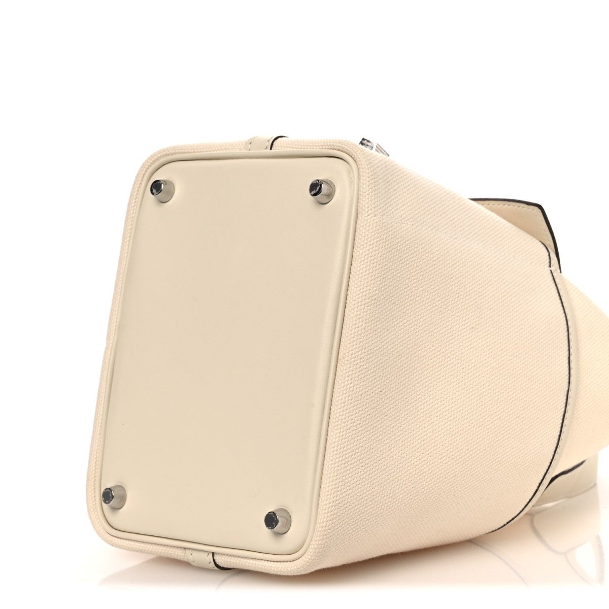 Cream canvas tote bag with rear panel studs and rounded side shape
