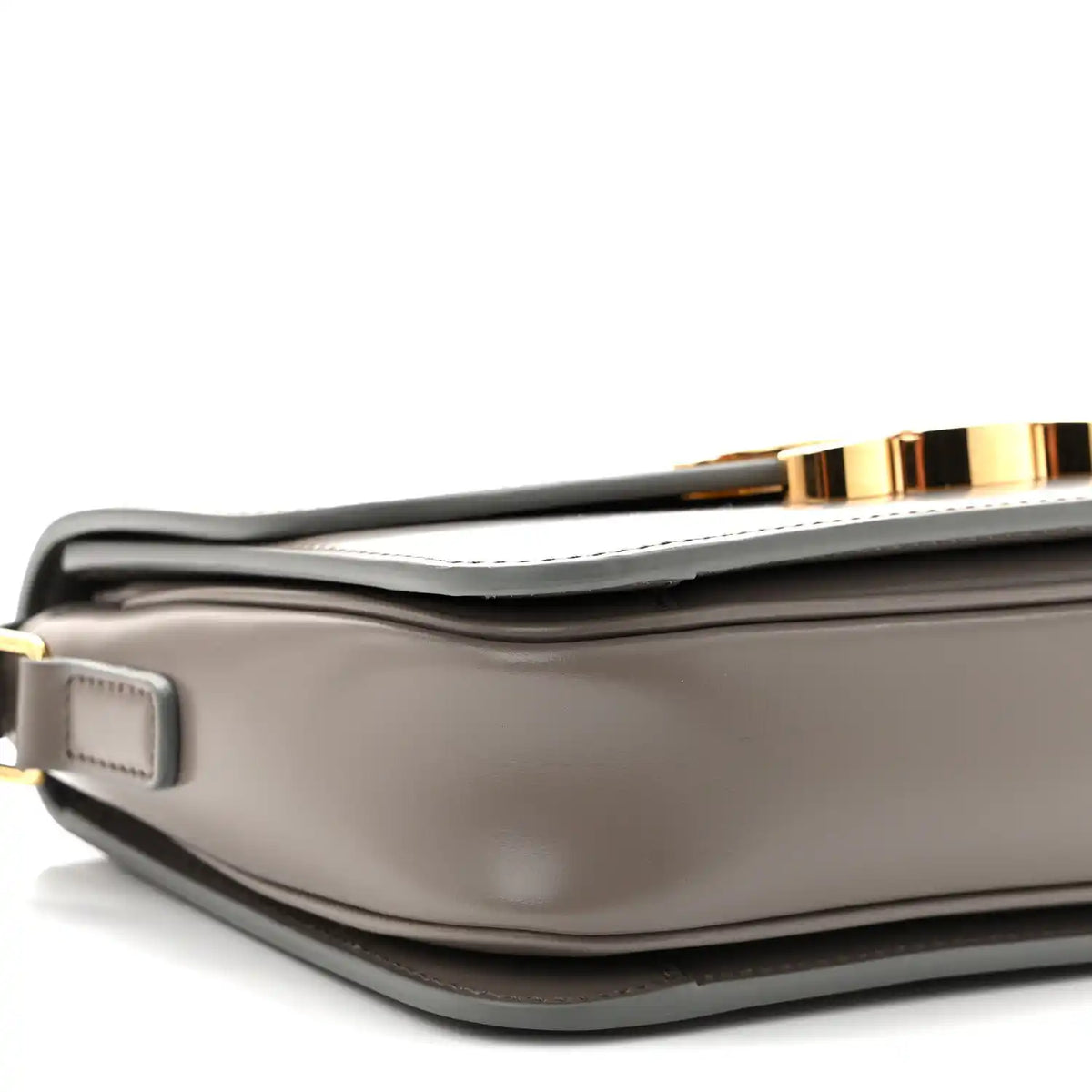Celine shiny calfskin shoulder bag close-up with strap attachment and gold-tone buckle