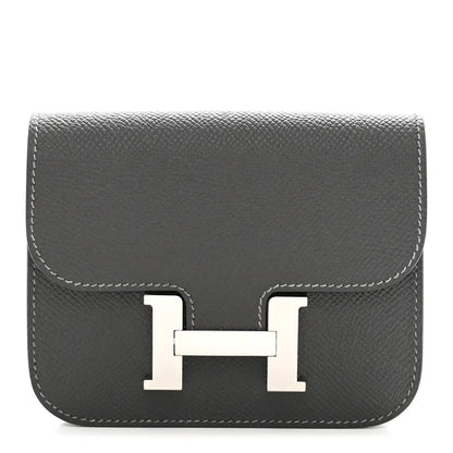Constance slim wallet front in dark textured leather with H clasp and contrast stitching