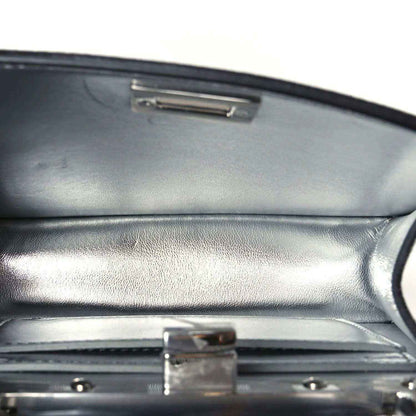Satchel interior flap with rectangular metal clasp and dark leather lining