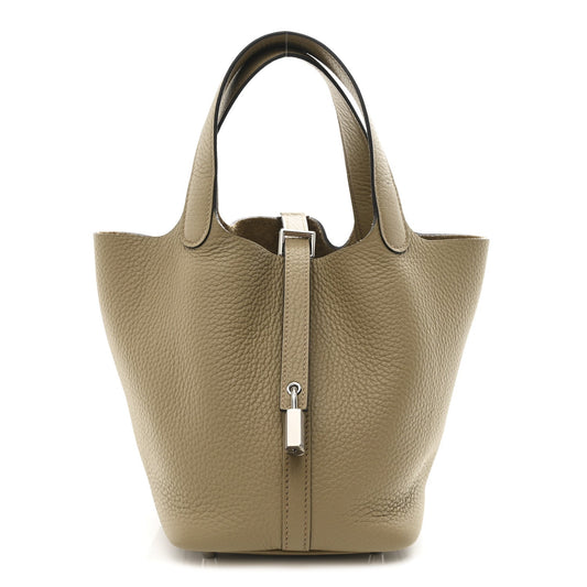 Beige leather mini tote bag with top handles and front lock closure