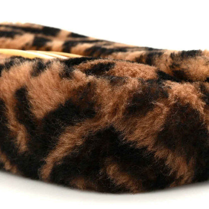 Tobacco brown and dark shearling with FF logo pattern, close-up on mini baguette.