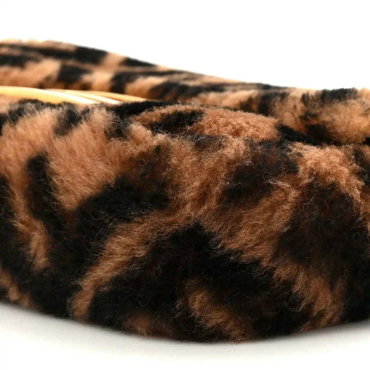Tobacco brown and dark shearling with FF logo pattern, close-up on mini baguette.