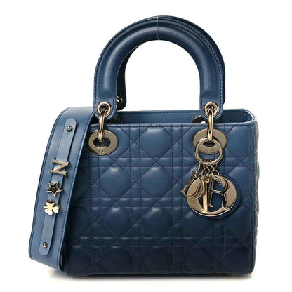 Small quilted leather handbag in indigo blue with gold-tone hardware and two top handles