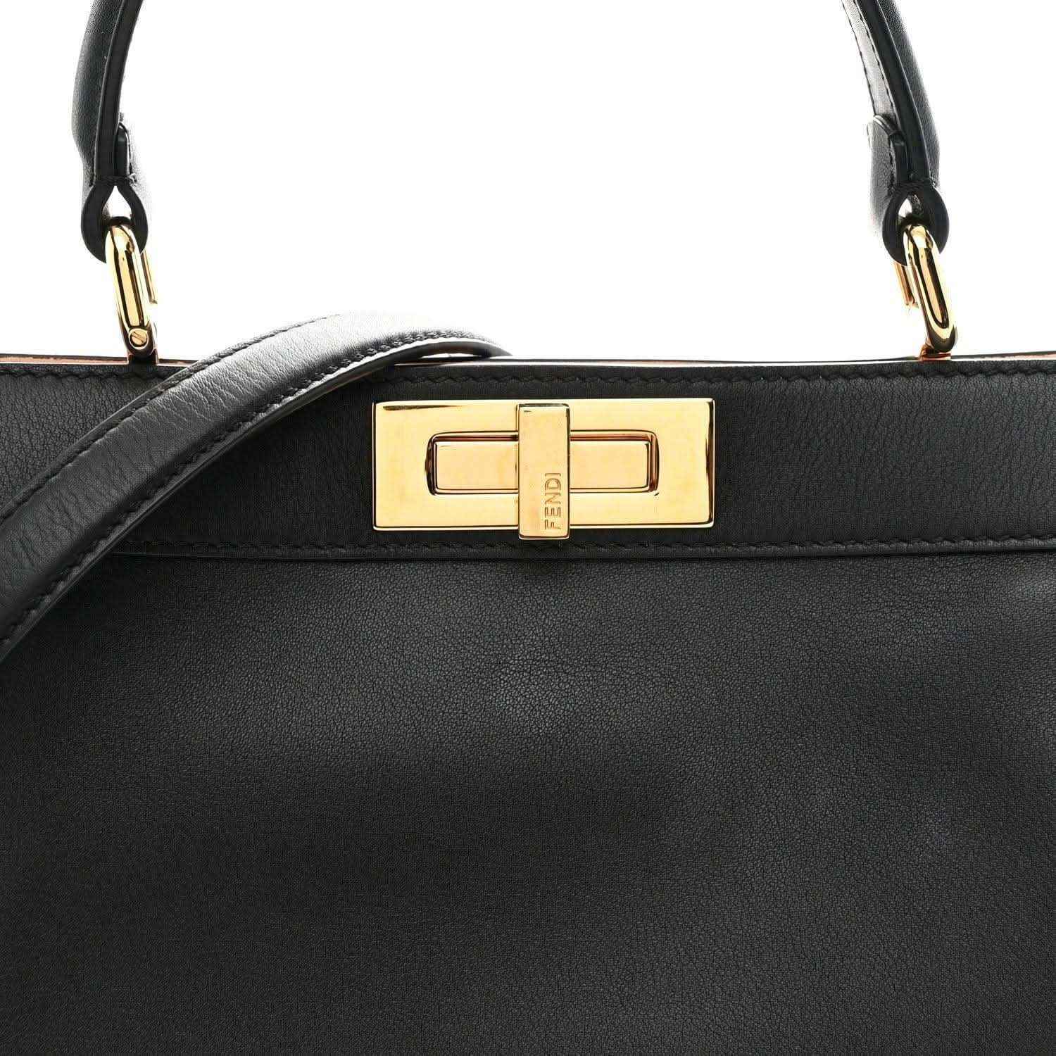 Black satchel front flap with gold-tone FF clasp and top handle attachments