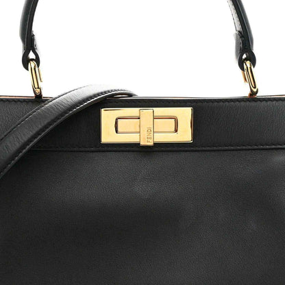 Black satchel front flap with gold-tone FF clasp and top handle attachments