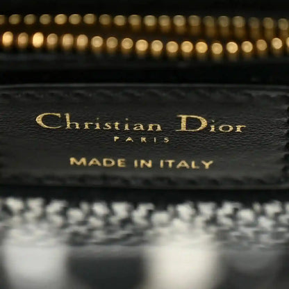 Mini canvas bag label reading Christian Dior and MADE IN ITALY on interior patch