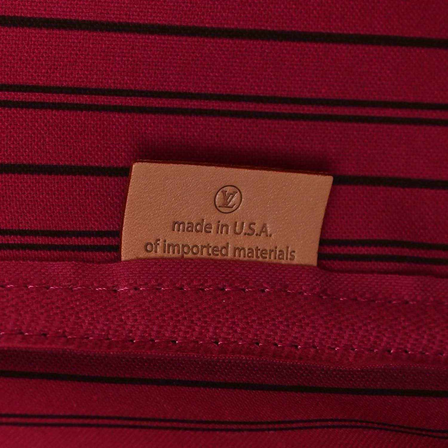 Tote bag interior label reading made in USA on burgundy striped fabric
