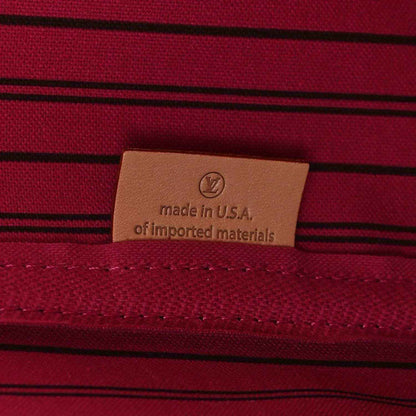 Tote bag interior label reading made in USA on burgundy striped fabric