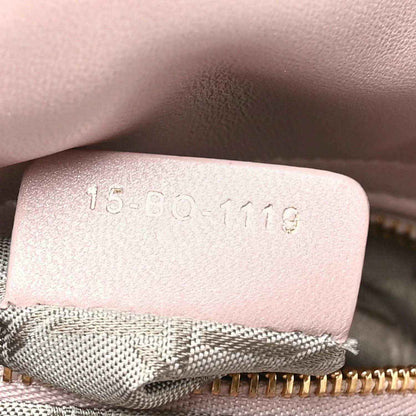Mini Lady Dior handbag interior tag with embossed code on light pink leather