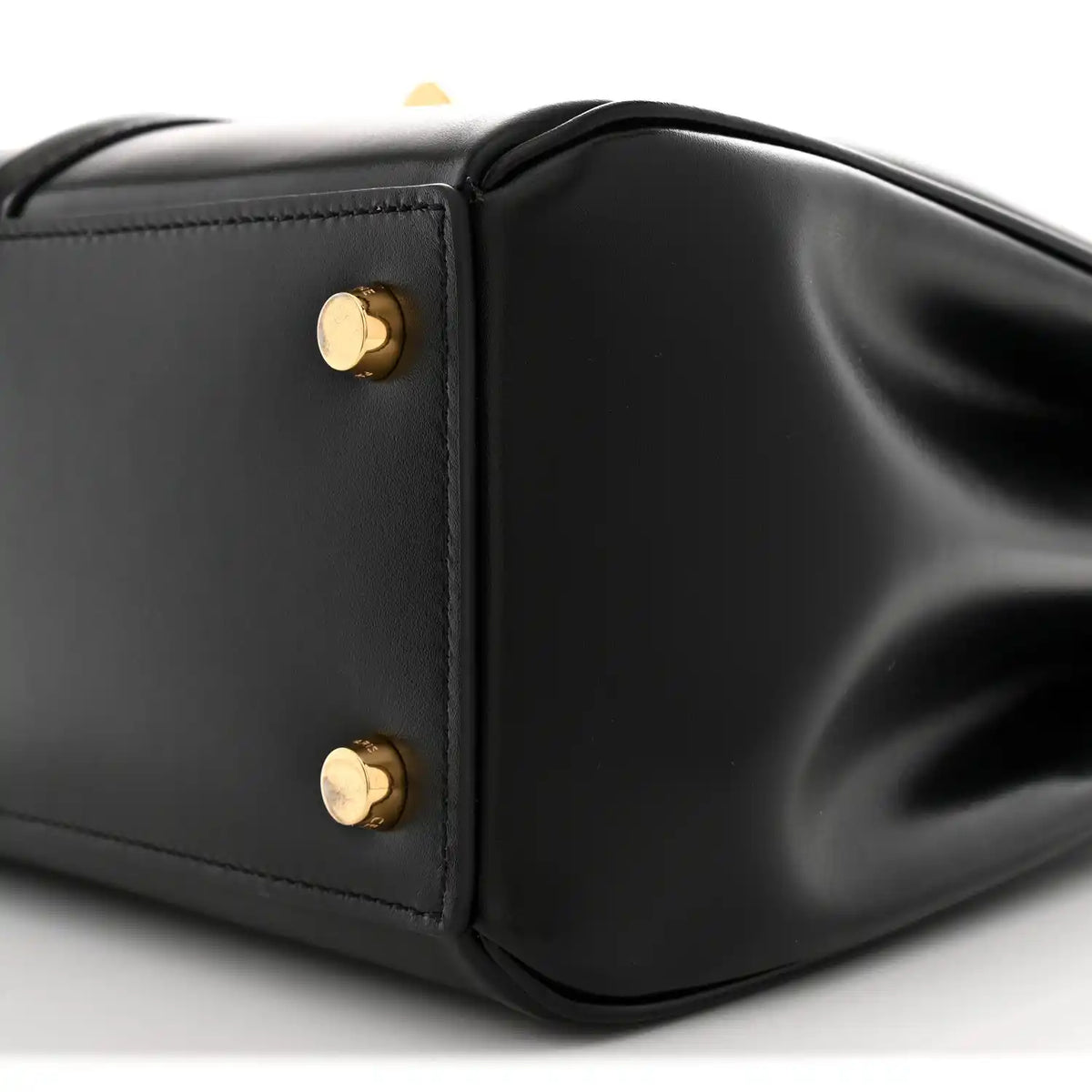 Black leather corner with two gold snap studs and smooth satin finish