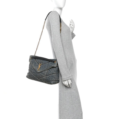 Denim quilted puffer satchel with gold chain strap shown on mannequin