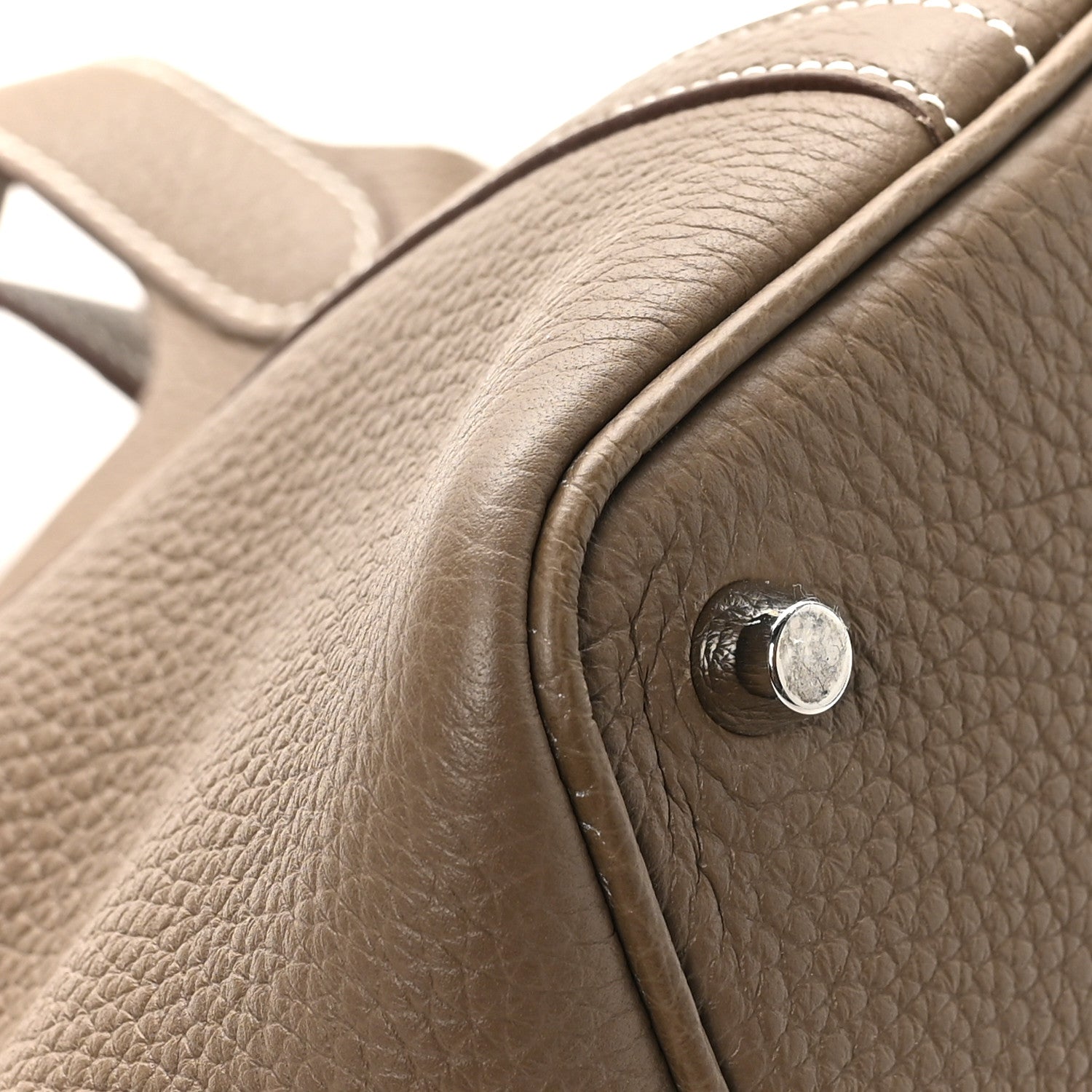 Taupe pebbled leather tote bag with turn-lock hardware and curved handle edge