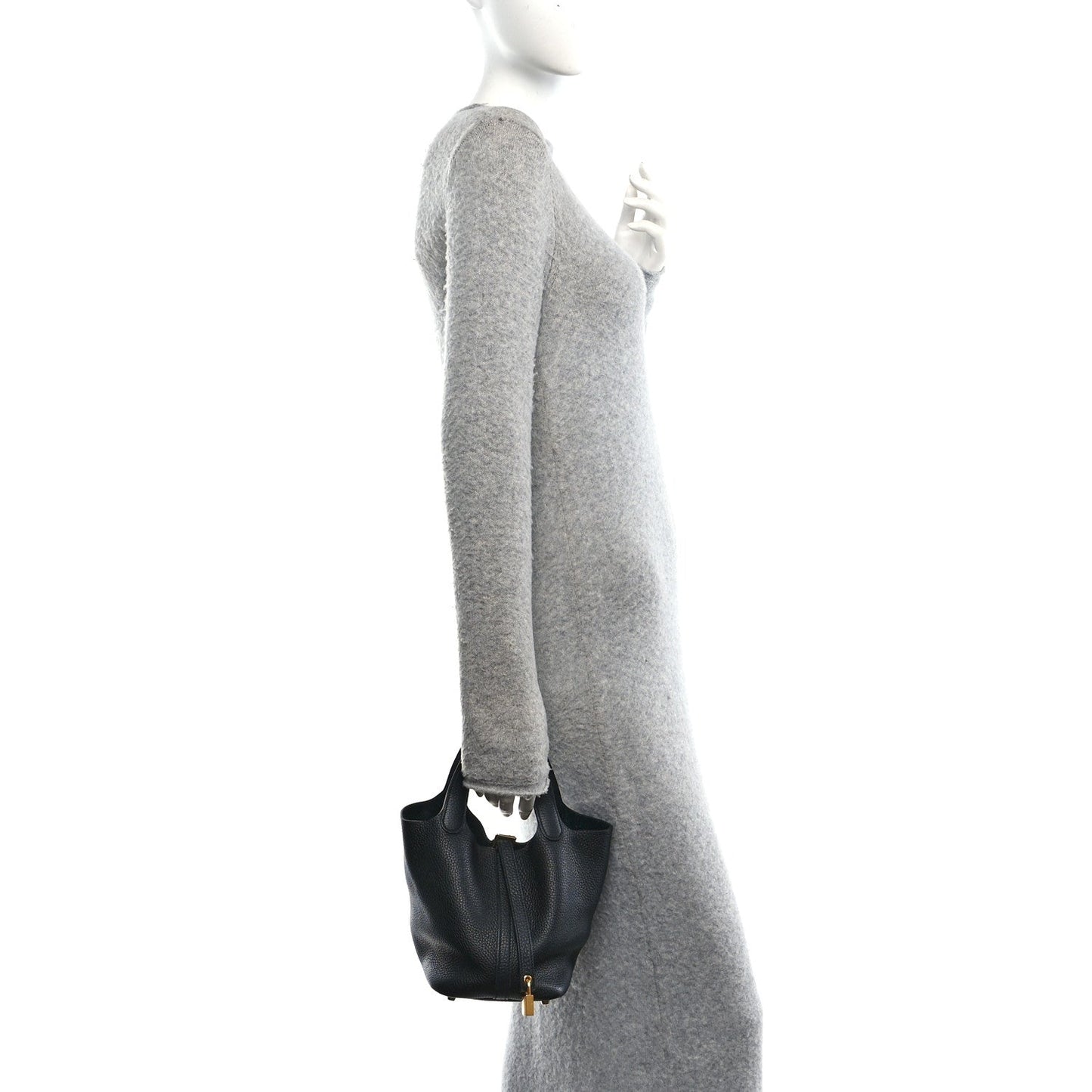 Black pebbled leather tote bag shown from the side with top handles and zipper