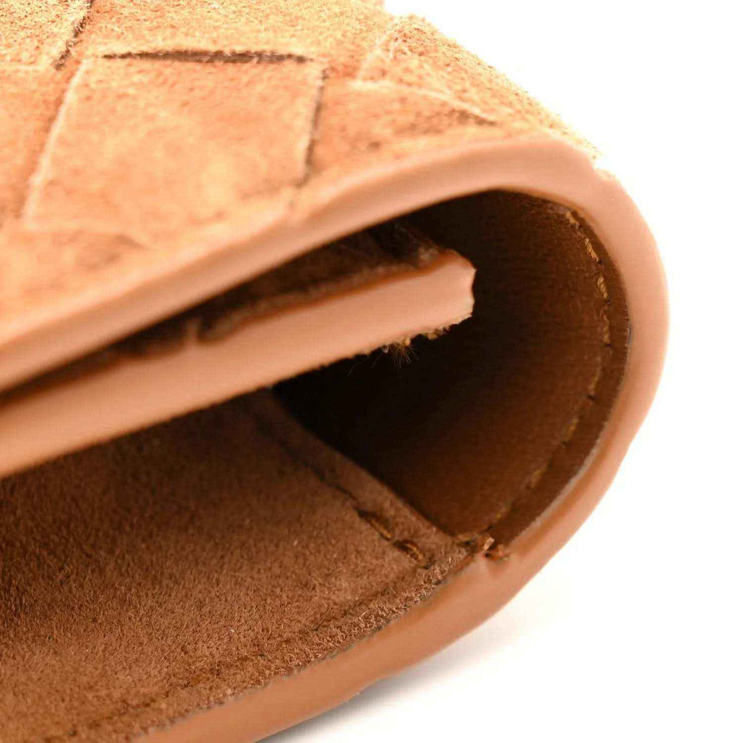 Amber suede clutch opening showing interior lining and curved leather trim