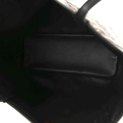 Reversible mini tote bag close-up of black leather trim and edge stitching