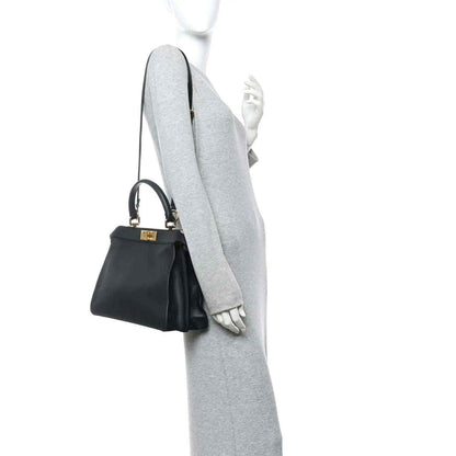 Black Fendi Peekaboo medium satchel with crossbody strap and gold-tone clasp