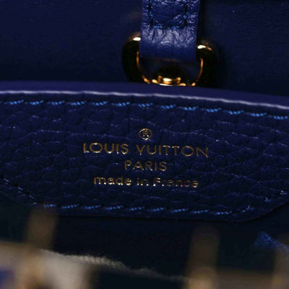 Close-up of Louis Vuitton stamped pocket on dark blue pebbled leather