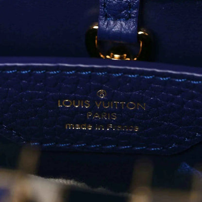 Close-up of Louis Vuitton stamped pocket on dark blue pebbled leather