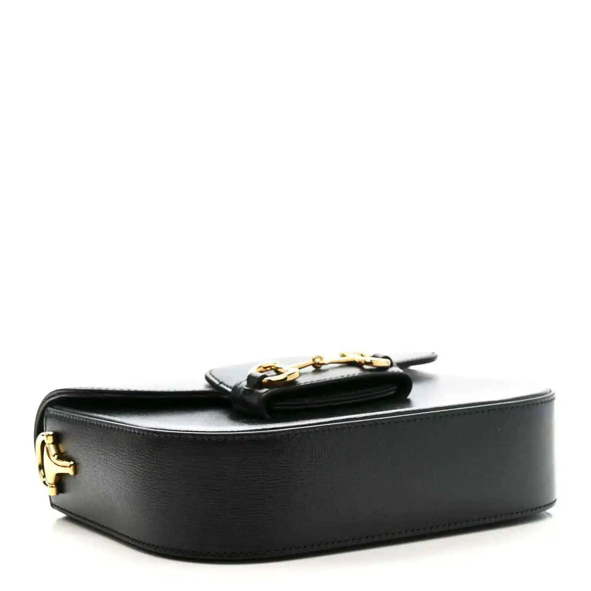 Black leather mini bag with gold-tone horsebit hardware and curved flap top