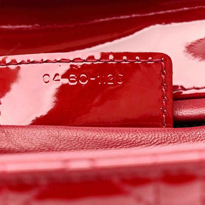 Red leather date code stamp on interior panel with stitched edge.