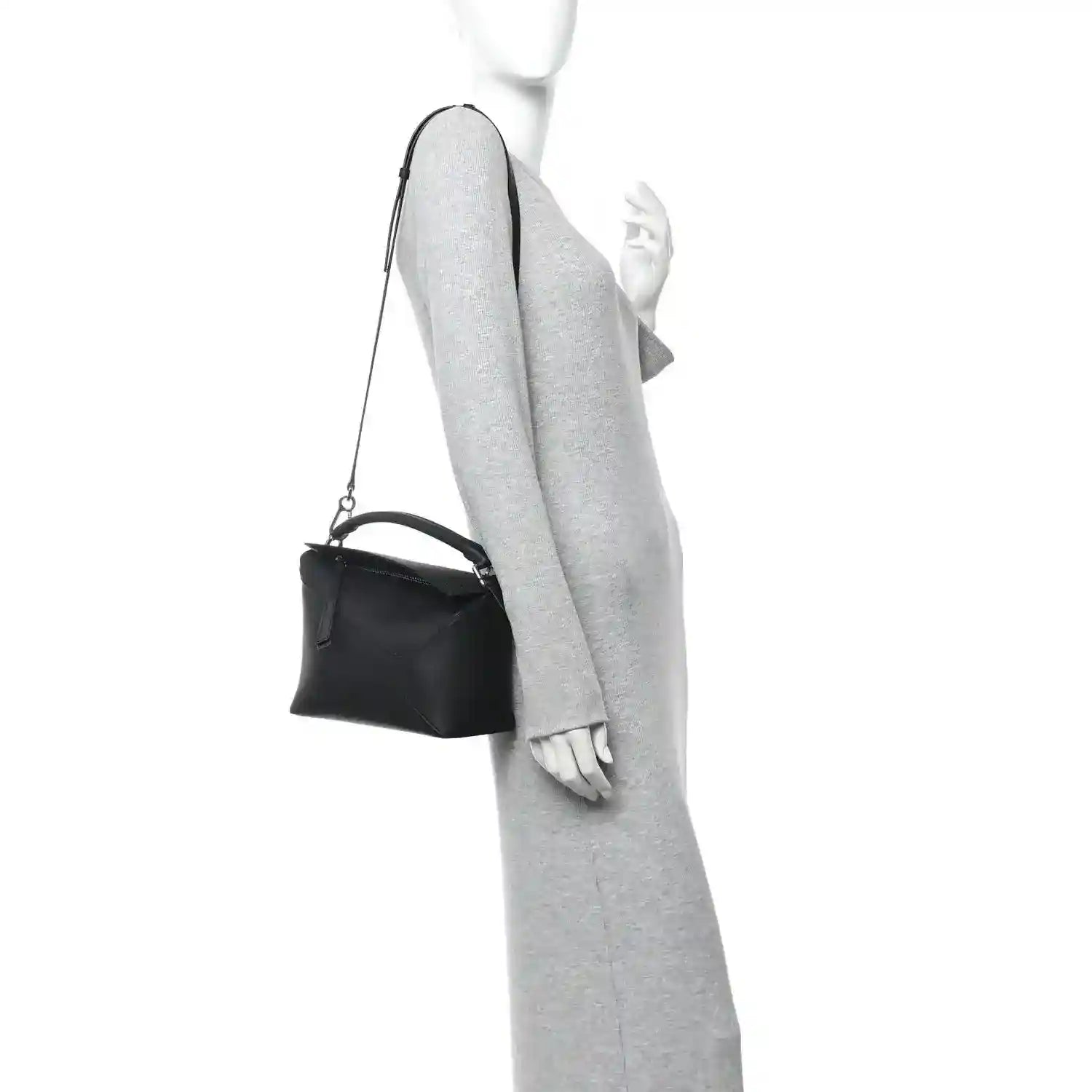 Small Puzzle Edge shoulder bag in black leather, worn on shoulder with crossbody strap