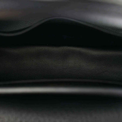 Black leather mini handbag close-up of stitching and embossed texture