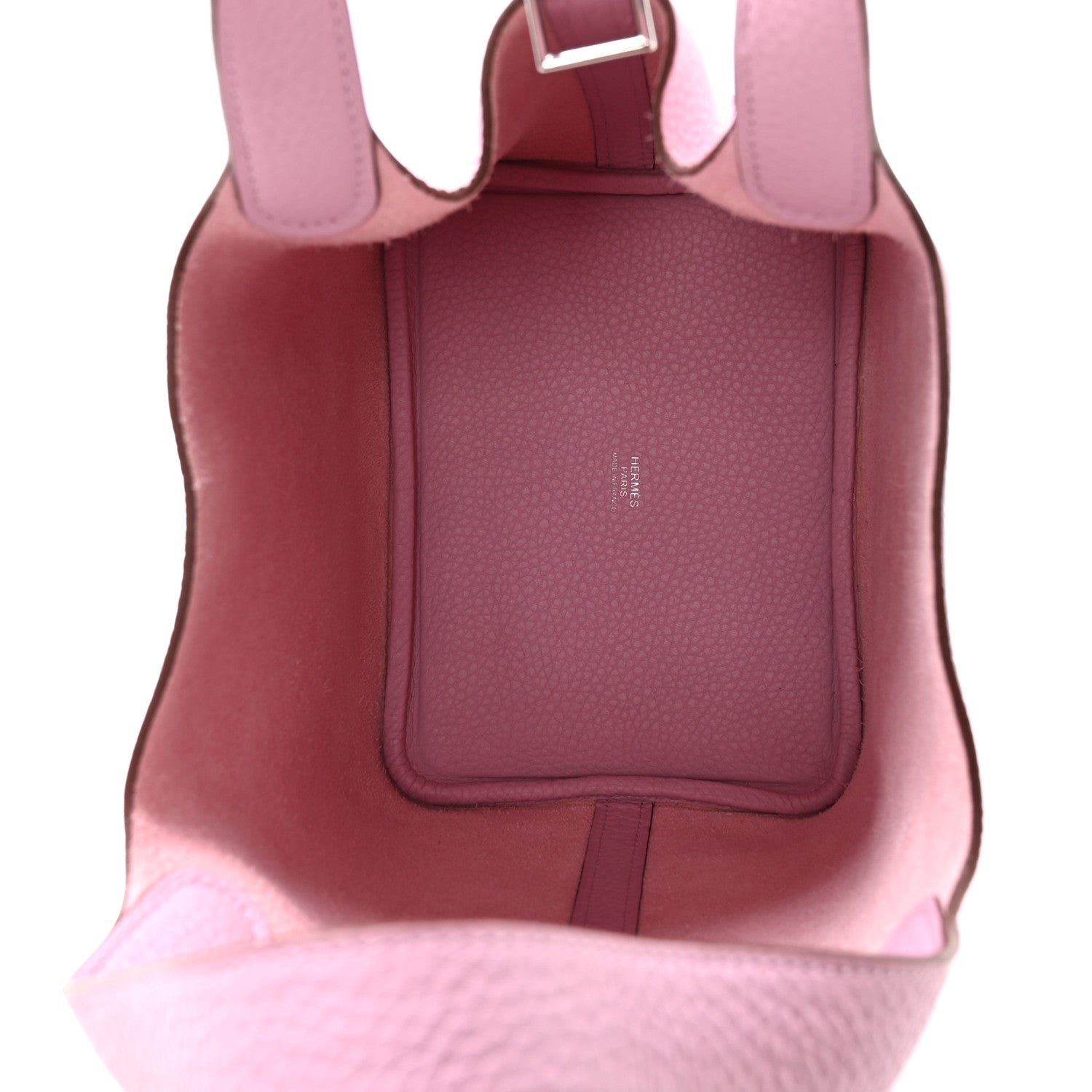 Rose pink handbag interior view with dark leather lining and pocket panel