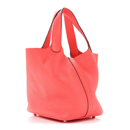 Rose pink leather tote bag with curved side profile and top handles