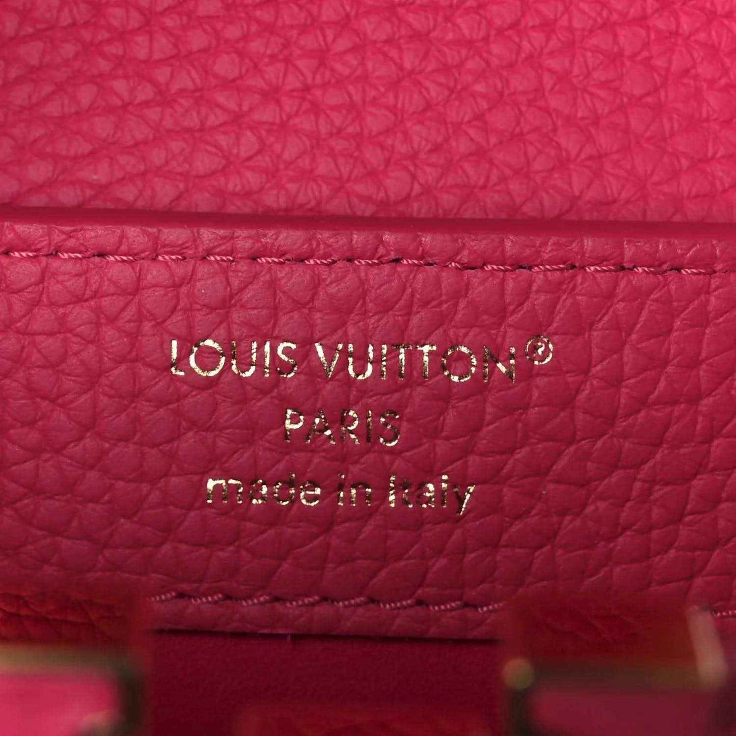 Magenta leather interior label reading “LOUIS VUITTON PARIS made in Italy”