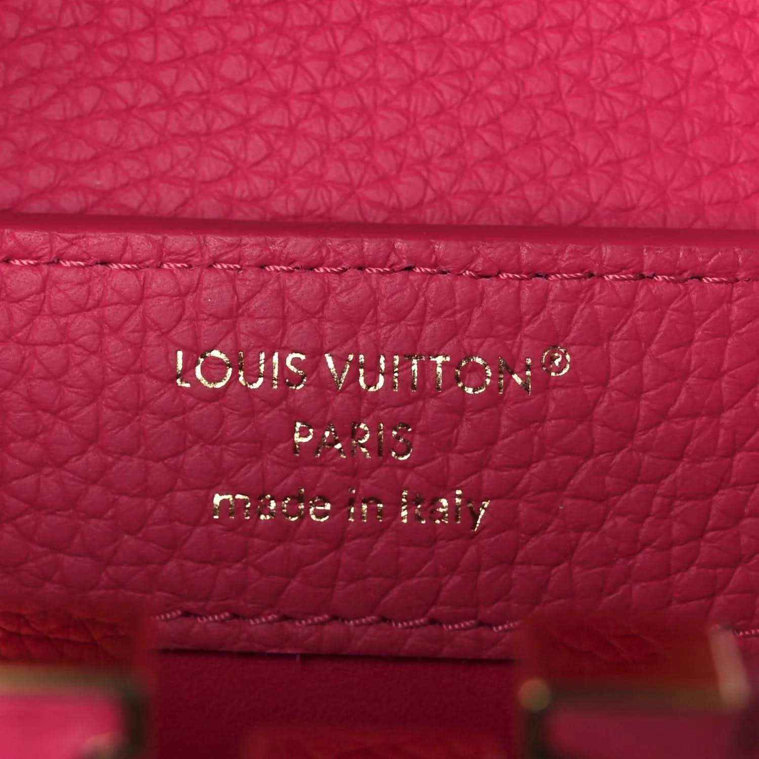 Magenta leather interior label reading “LOUIS VUITTON PARIS made in Italy”