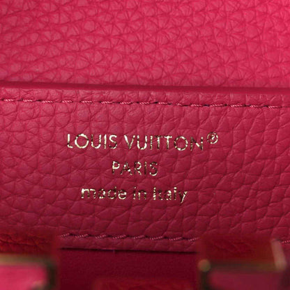 Magenta leather interior label reading “LOUIS VUITTON PARIS made in Italy”