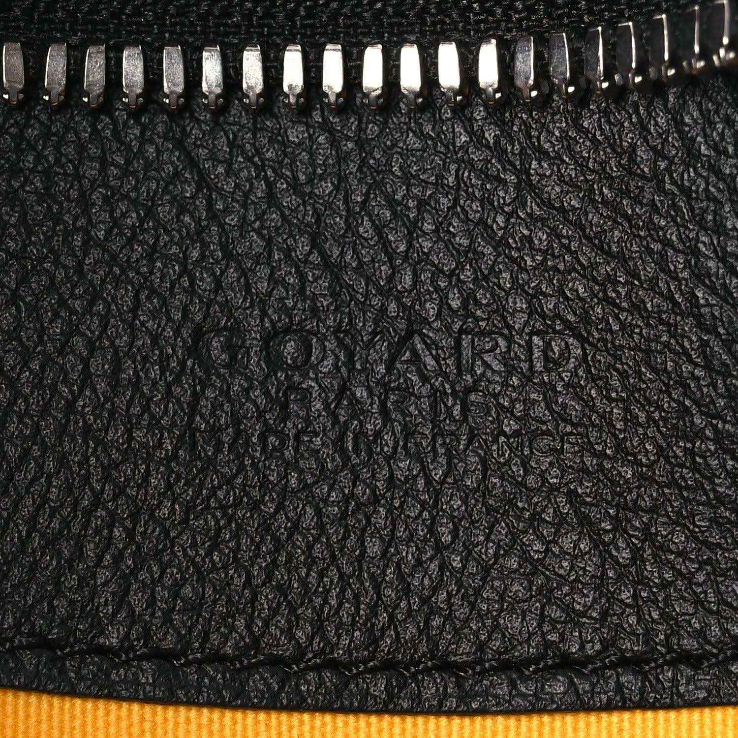 Black pebbled leather panel with zipper teeth and embossed logo area