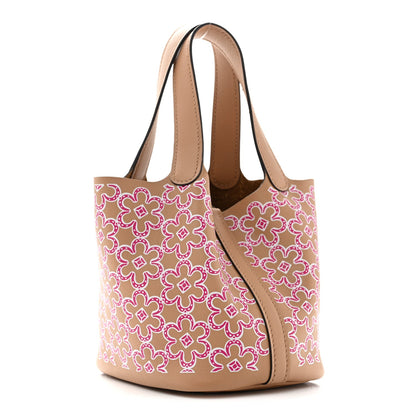 Micro tote bag with magenta floral print, tan handles, and lock clasp
