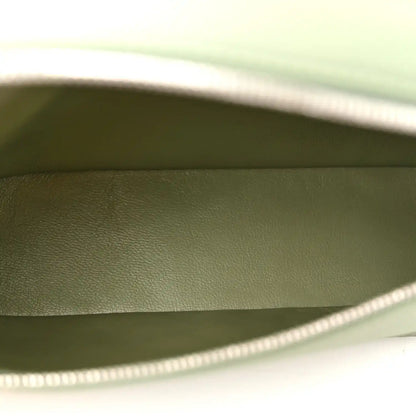Sage green leather pouch interior with top zipper edge visible